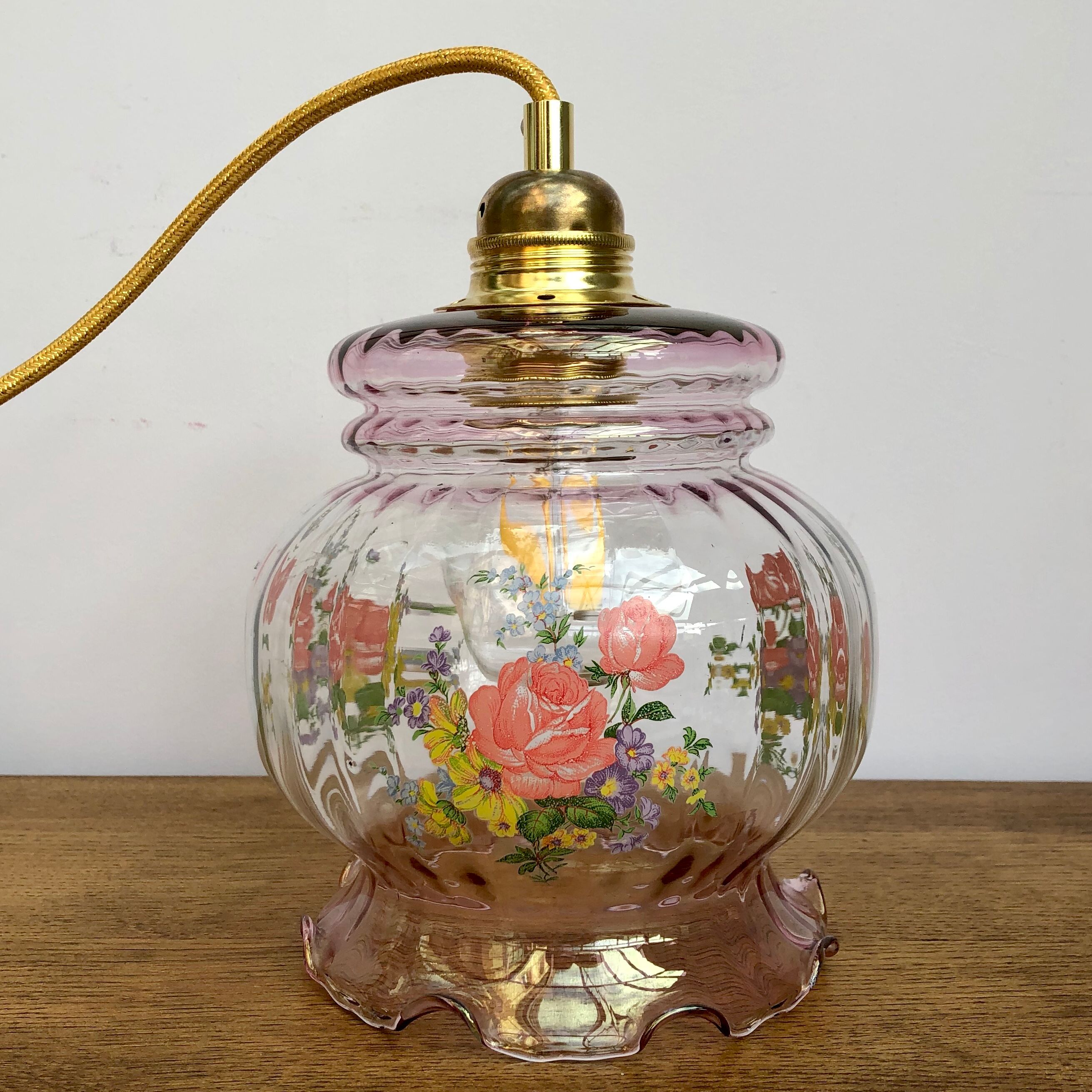 Vintage pink glass hand lamp with flower motifs