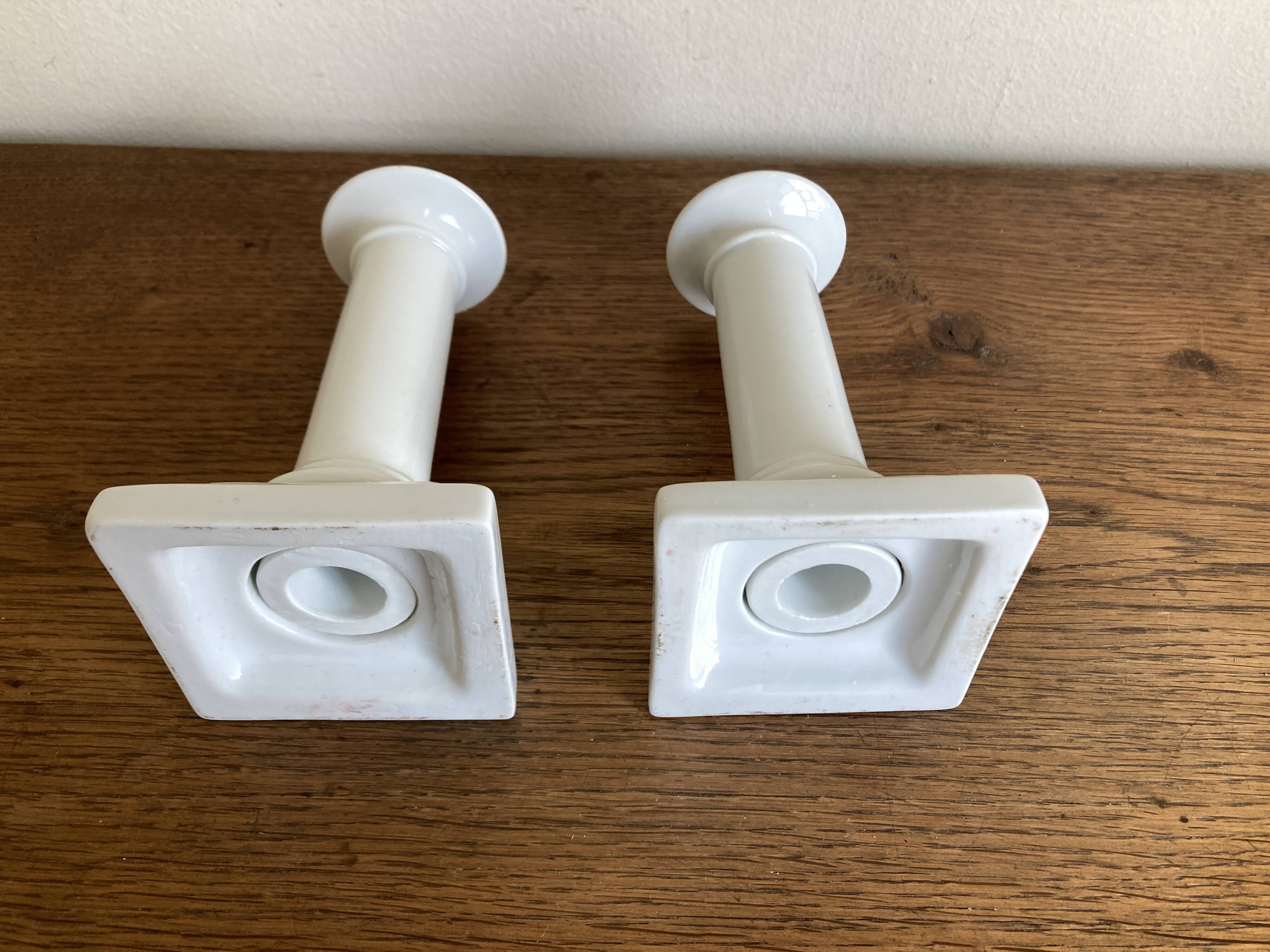 Pair of neo-classical Empire candlesticks from the late 19th century in white porcelain.