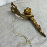 Bronze wall light, decorated with a bow and ribbon.