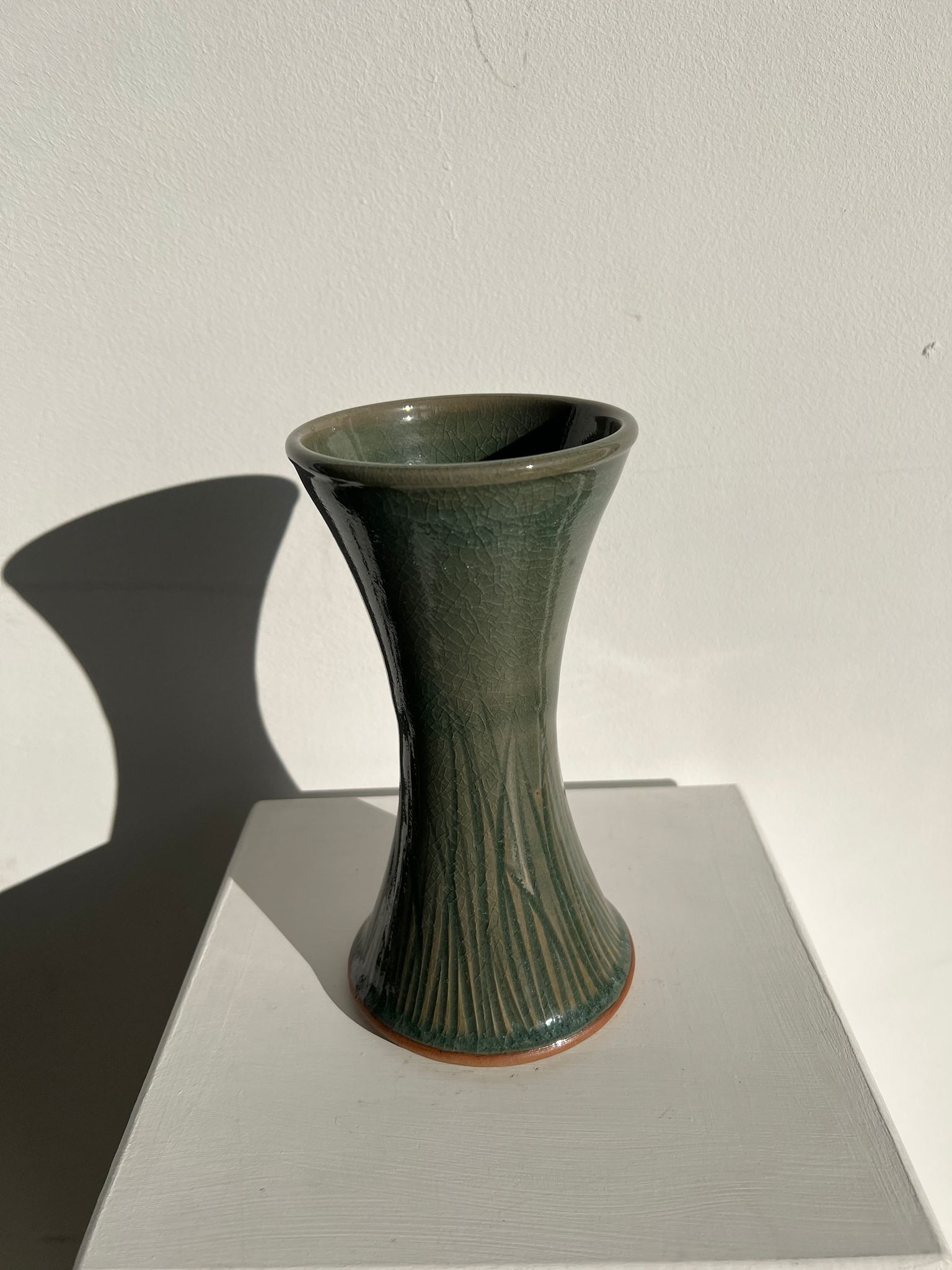 Dark green handcrafted vase with glazed ceramic grass blades