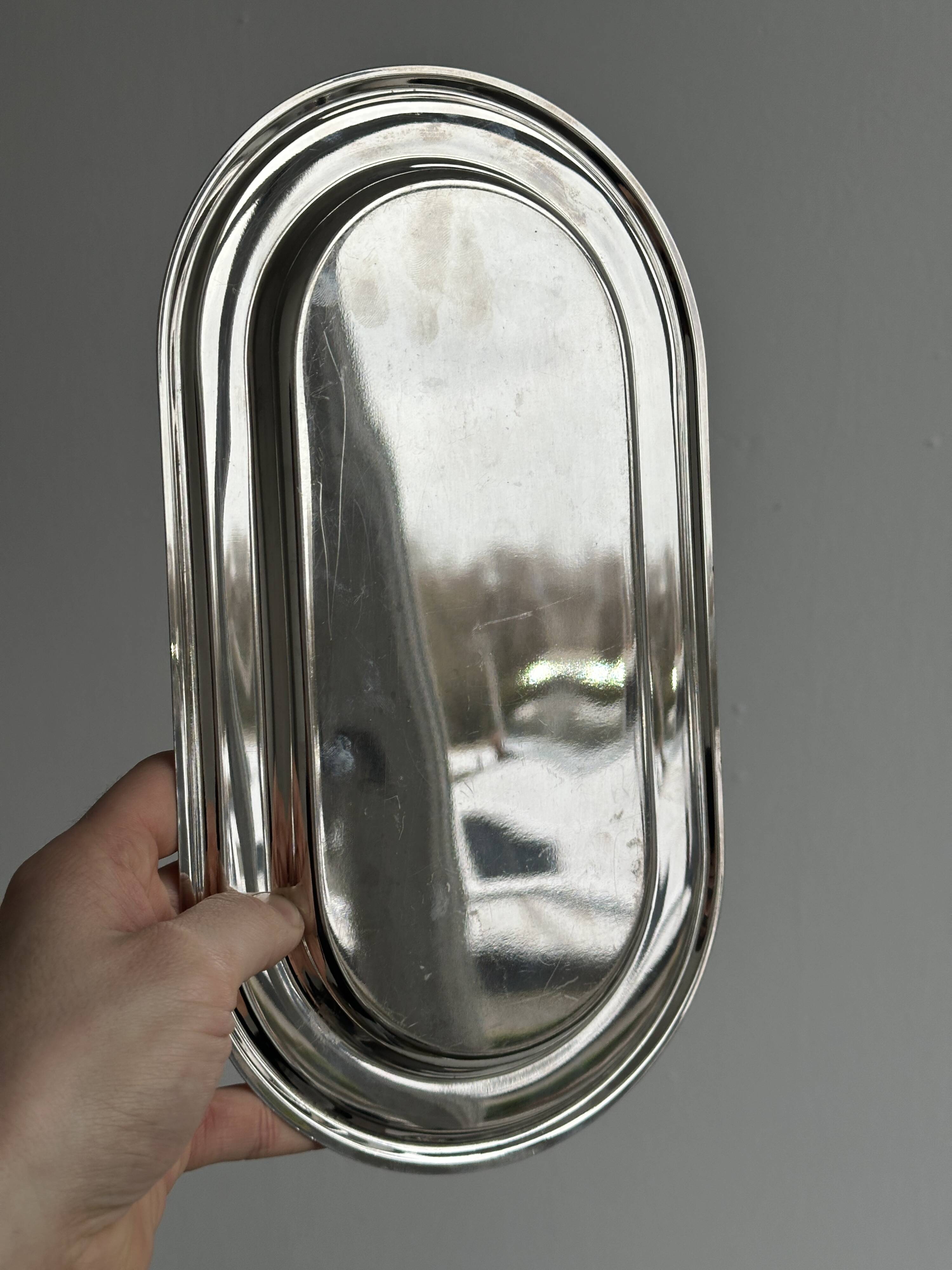 Small oval tray in shiny lightweight metal.
