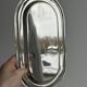 Small oval tray in shiny lightweight metal.