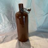 Old bottle in sandstone with a mechanical porcelein cap