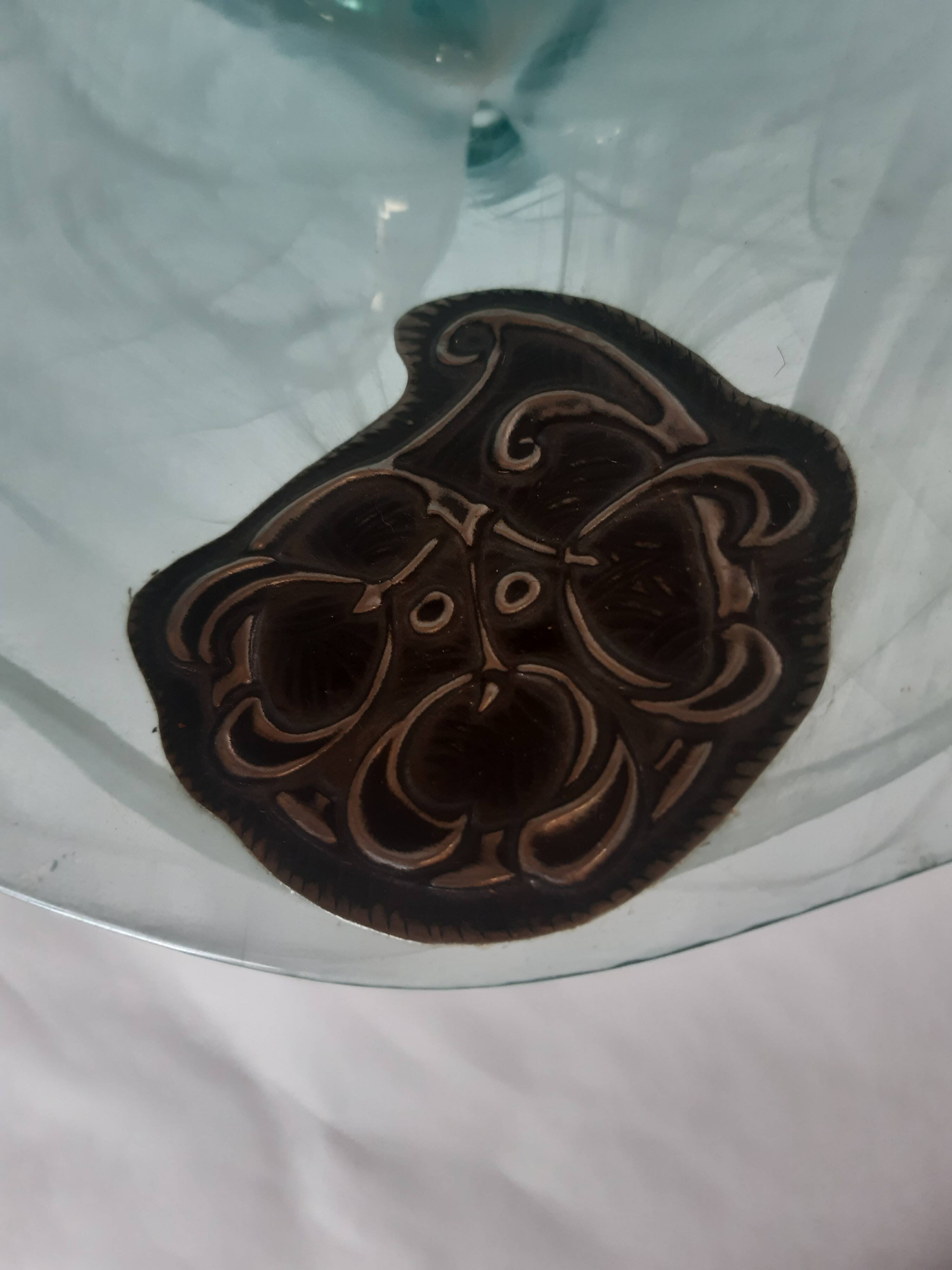 Handcrafted glass fruit bowl with ribbed design set with pewter medallions.