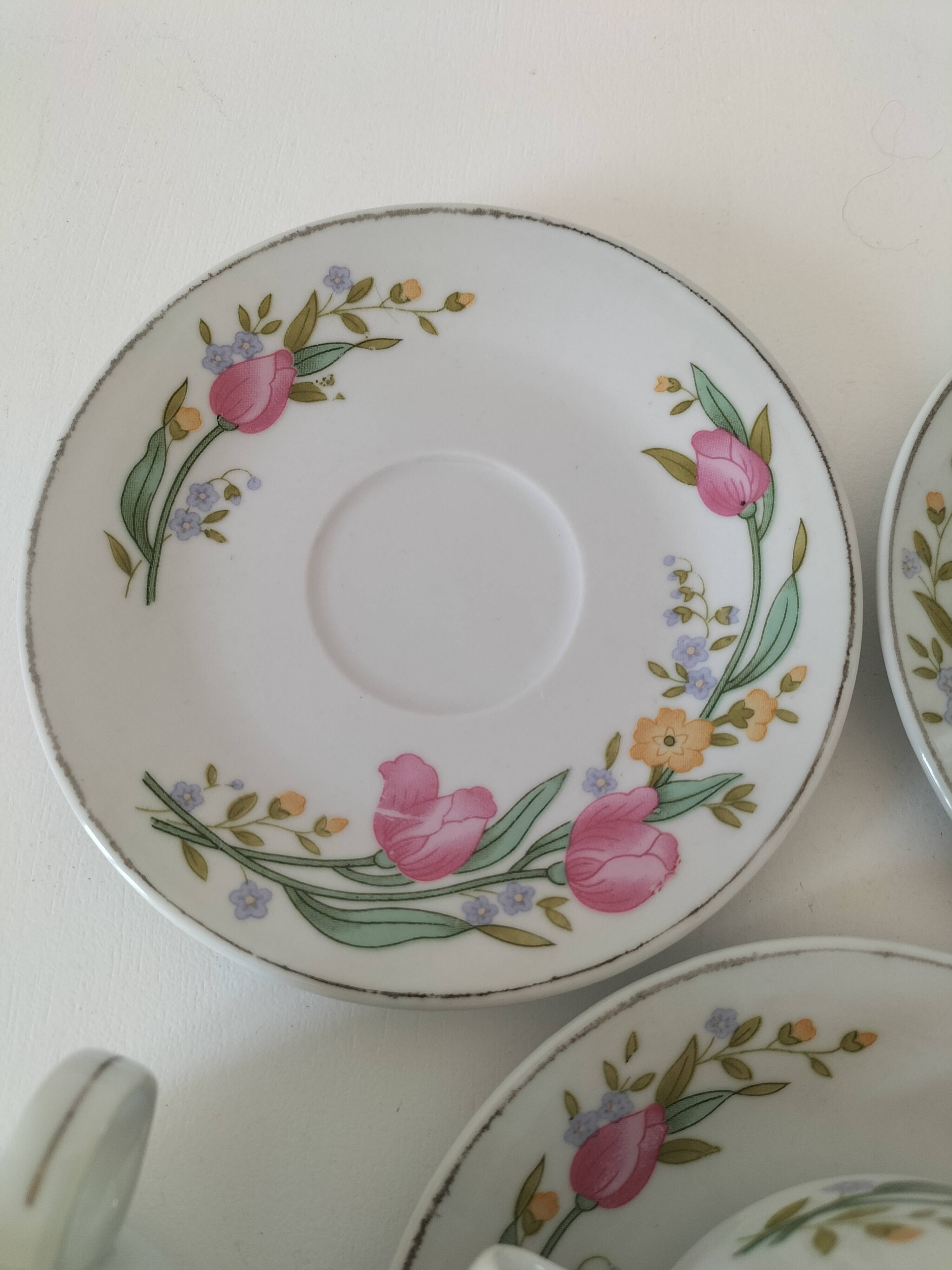 Trio of floral porcelain cups and saucers