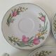 Trio of floral porcelain cups and saucers
