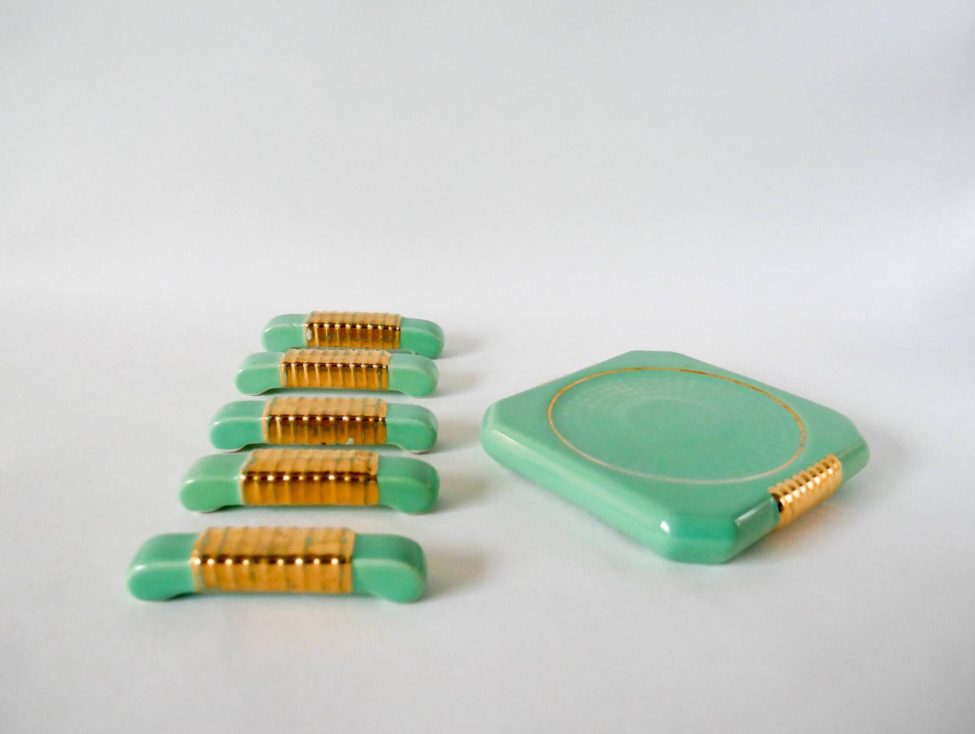 set of coasters and knife holders in mint green and gold art deco ceramic 1930