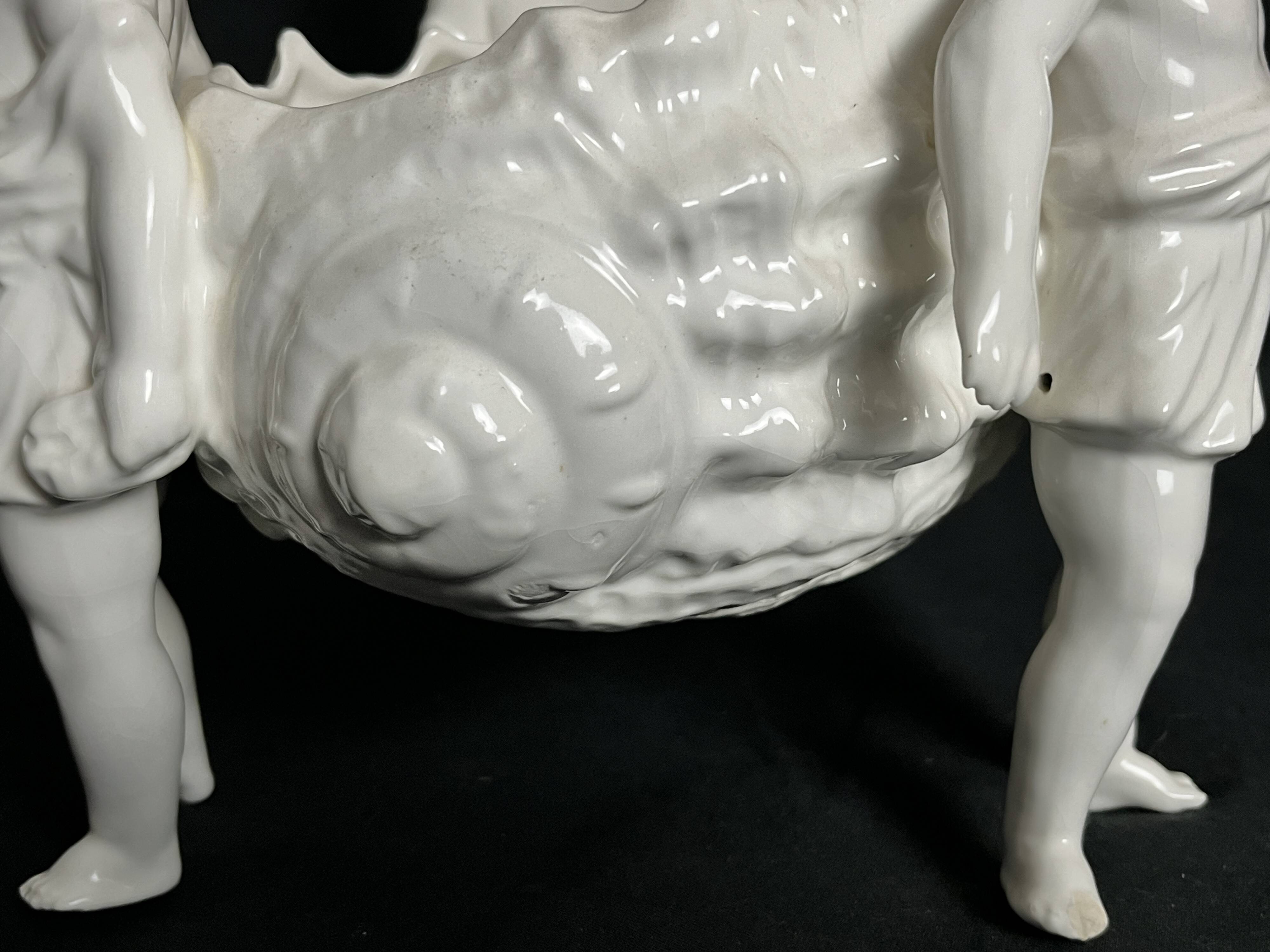 Porcelain, centerpiece with candle holder decorated with putti, 20th century