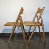 Pair of vintage wooden folding chairs with star pattern on seat