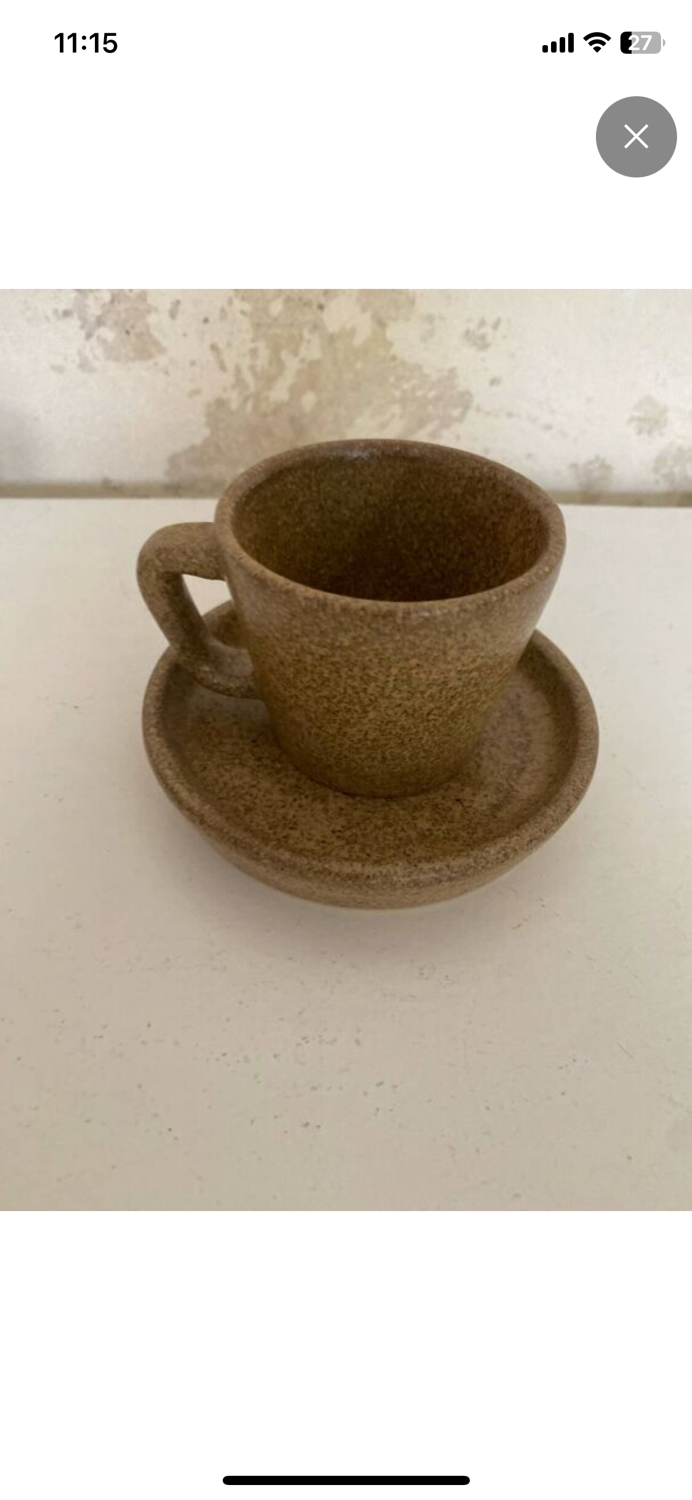 Set of stoneware coffee cups with saucers.