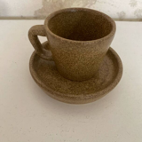 Set of stoneware coffee cups with saucers.
