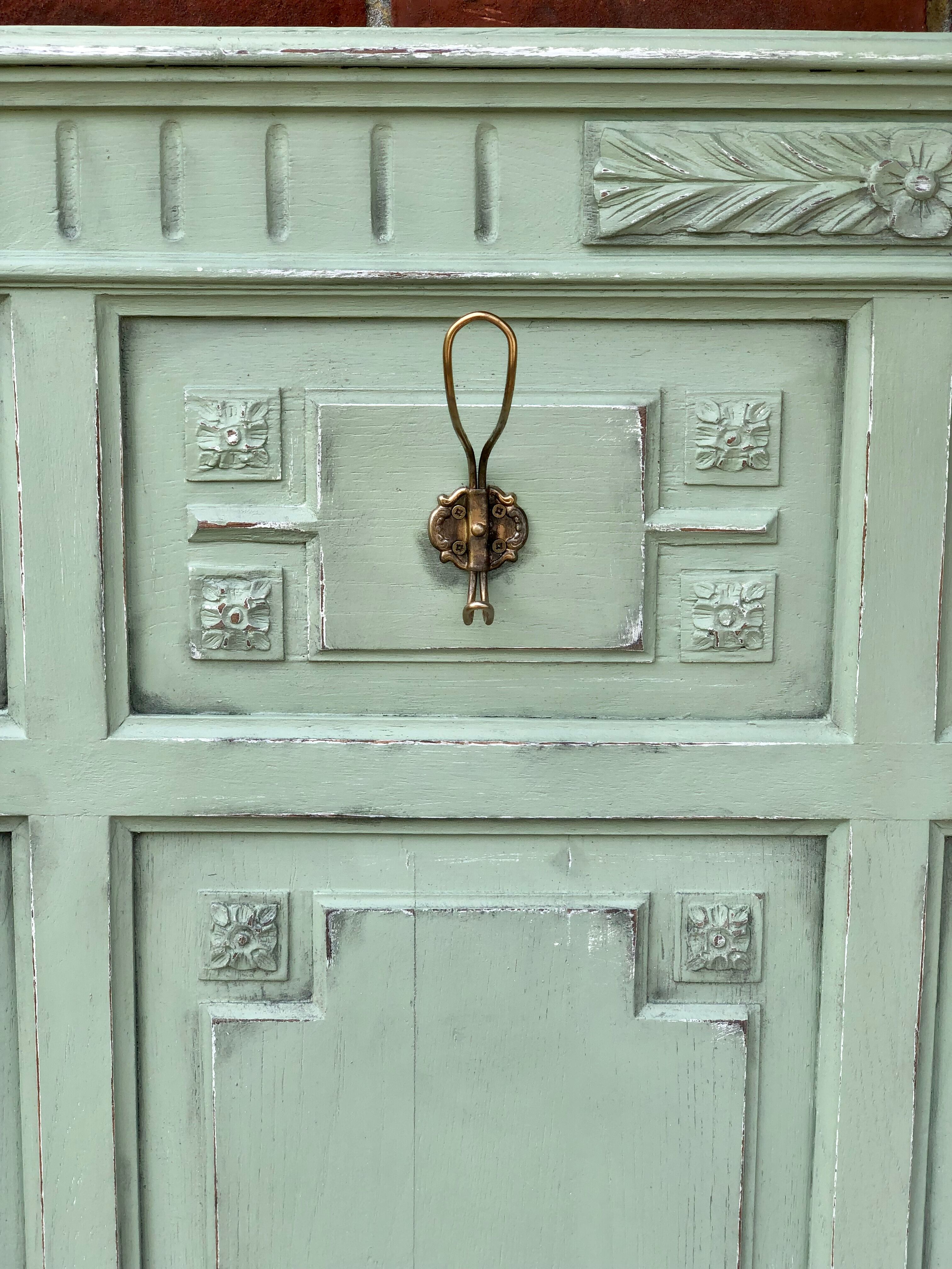 Cloakroom with sage green wall coats