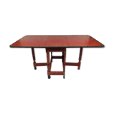 Painted wooden gateleg table with flower decorations on a red background