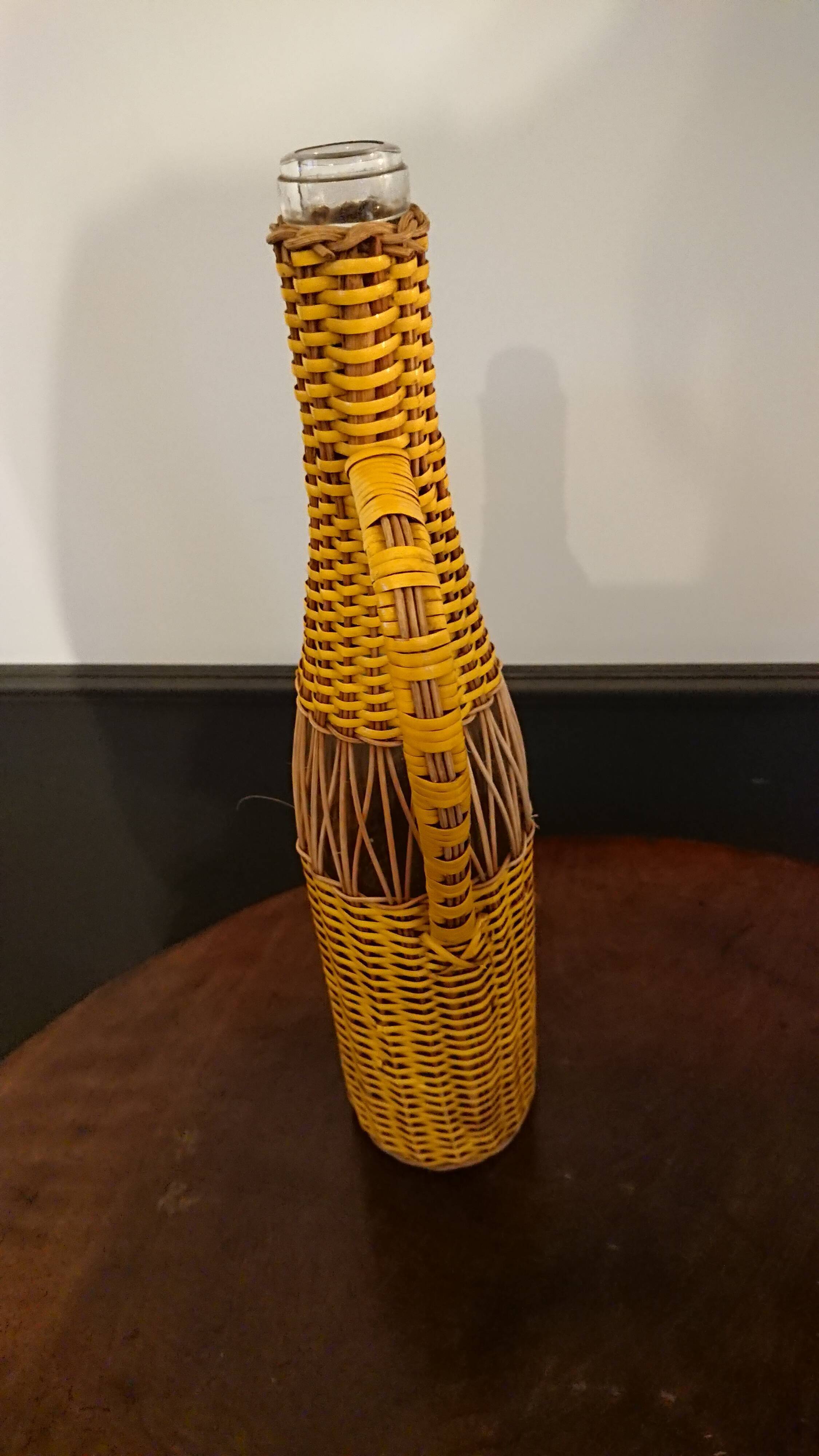 Natural and yellow braided glass and rattan bottle