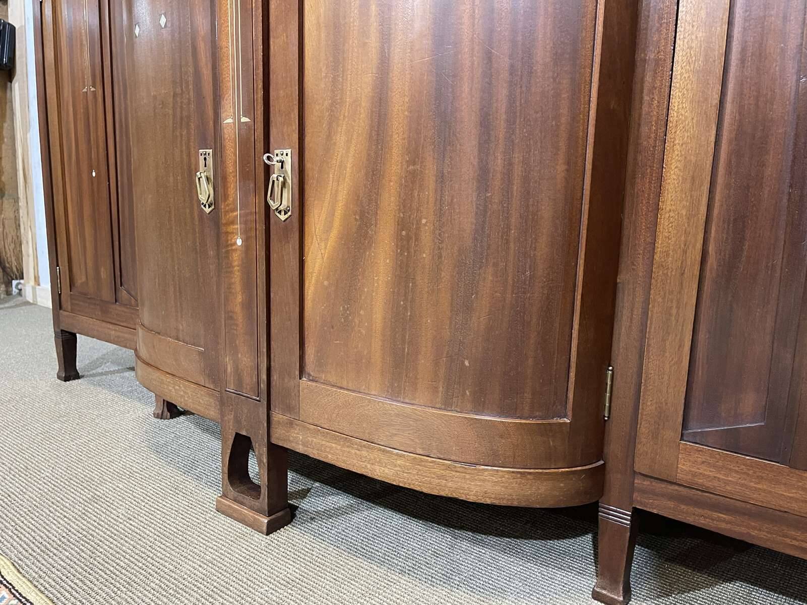 Art Nouveau mahogany buffet with clock in the style of G. Serrurier Bovy.