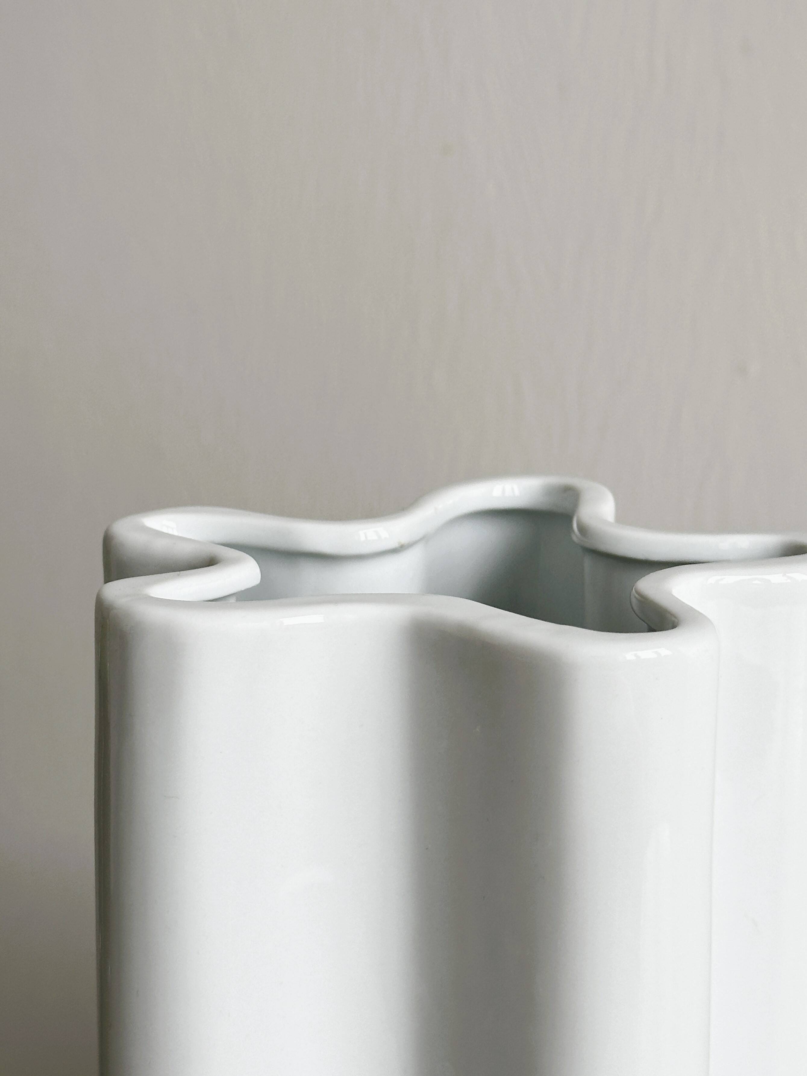 Modern white ceramic vase with wavy curves