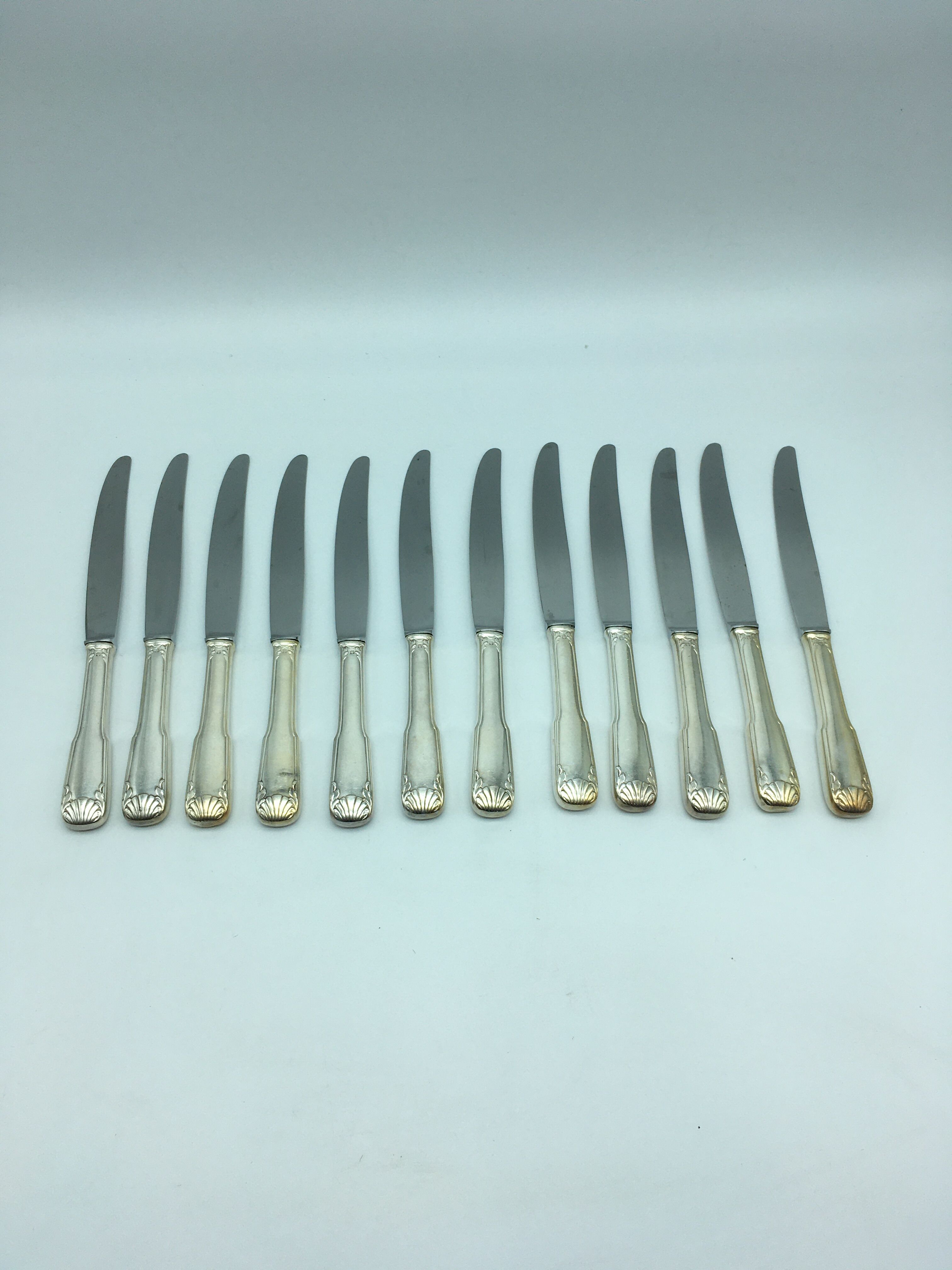12 silver metal knives.