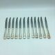 12 silver metal knives.