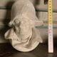 Marble sculpture, man's head in a hat.