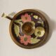 Set of 2 round golden metal candle holders and floral patterns