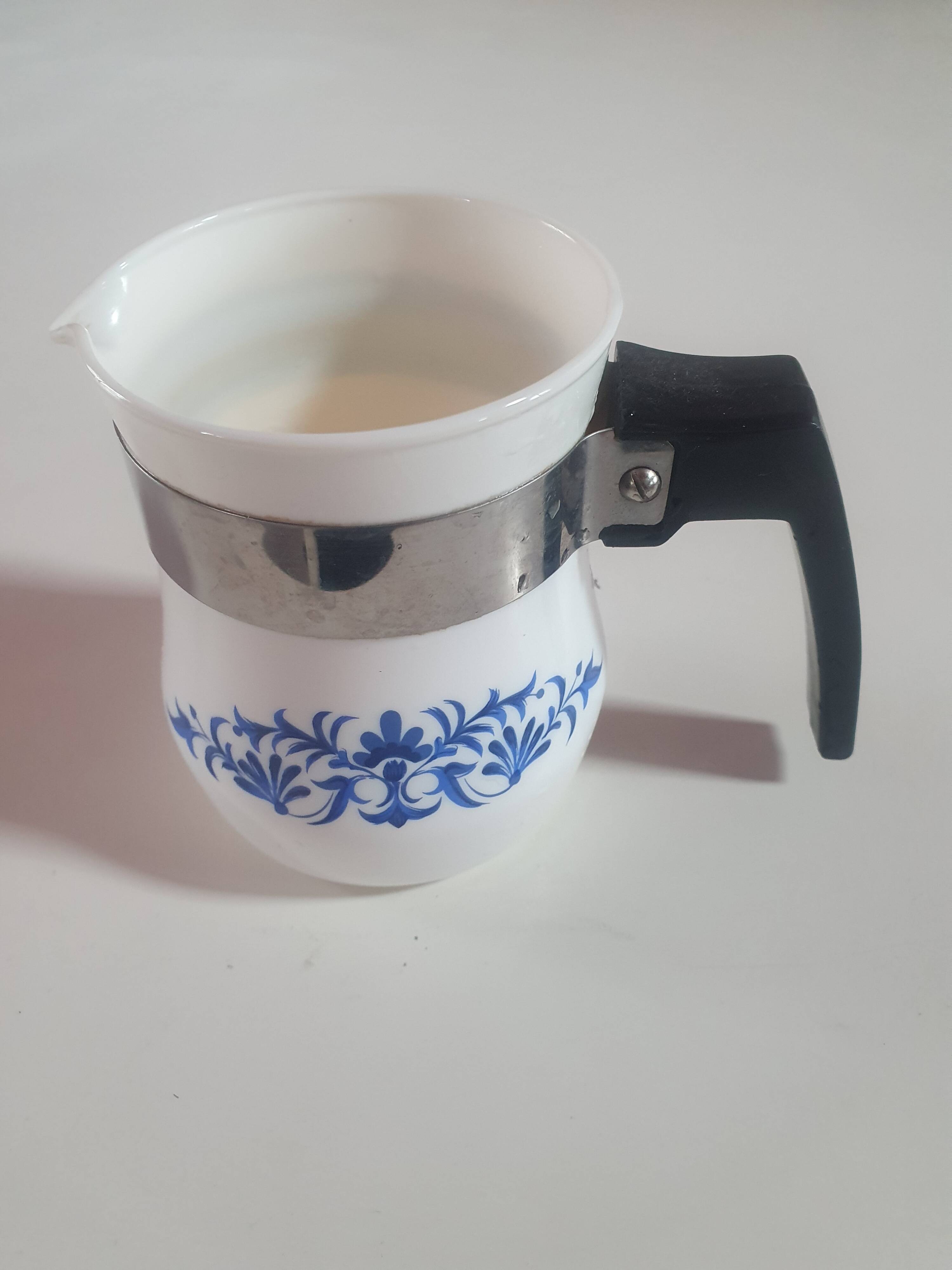 white ceramic milk jug with blue flowers, metal handle