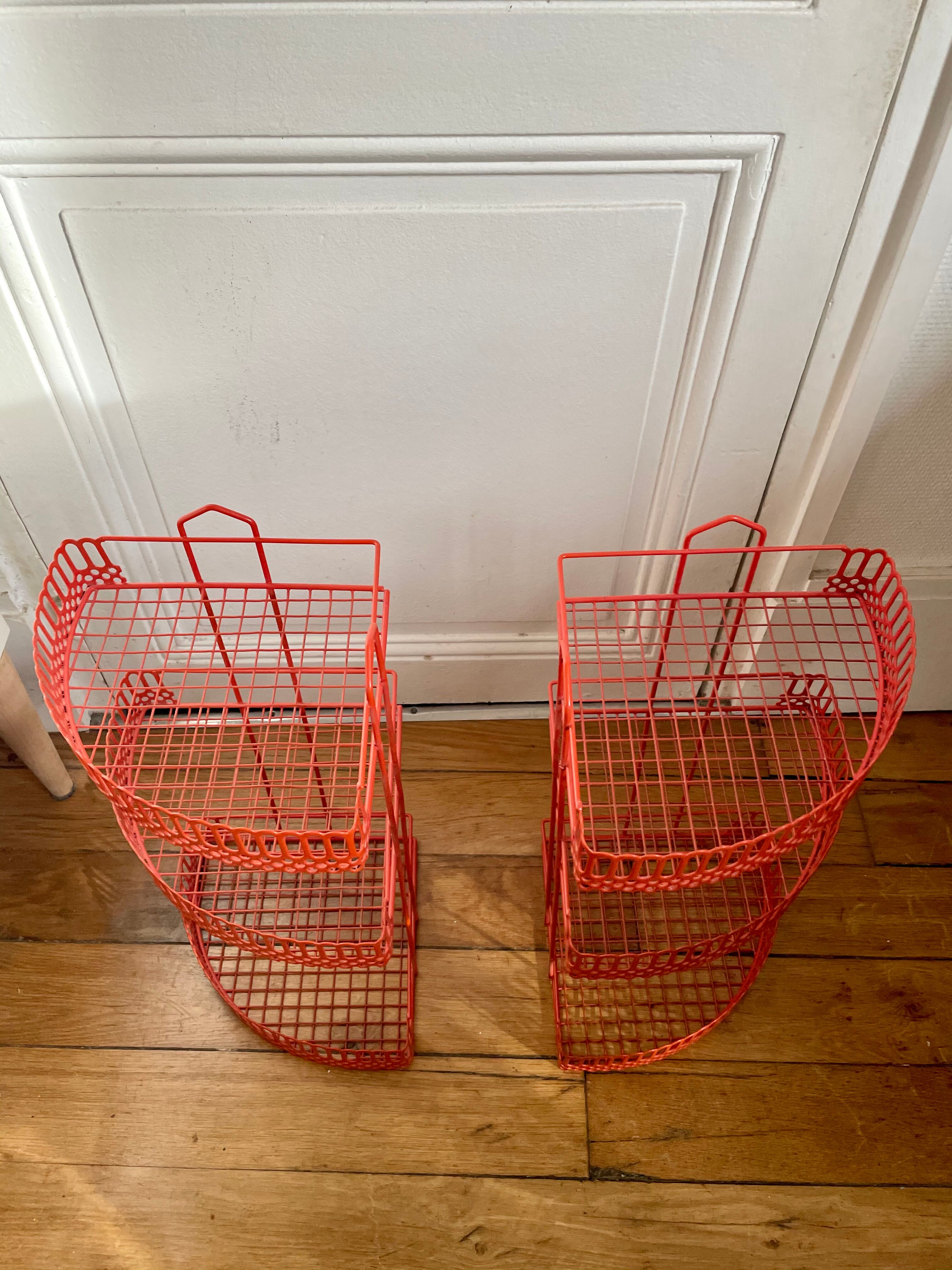 Red enamelled metal wall shelves
