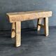 Ancient Chinese farm bench in patinated wood, small rustic stool.