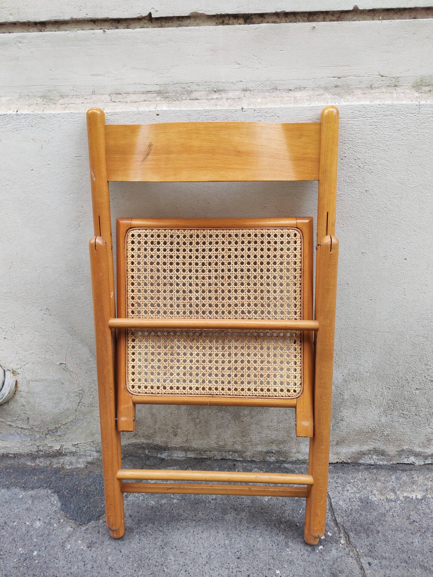Wooden folding chair with caning from the 1980s.