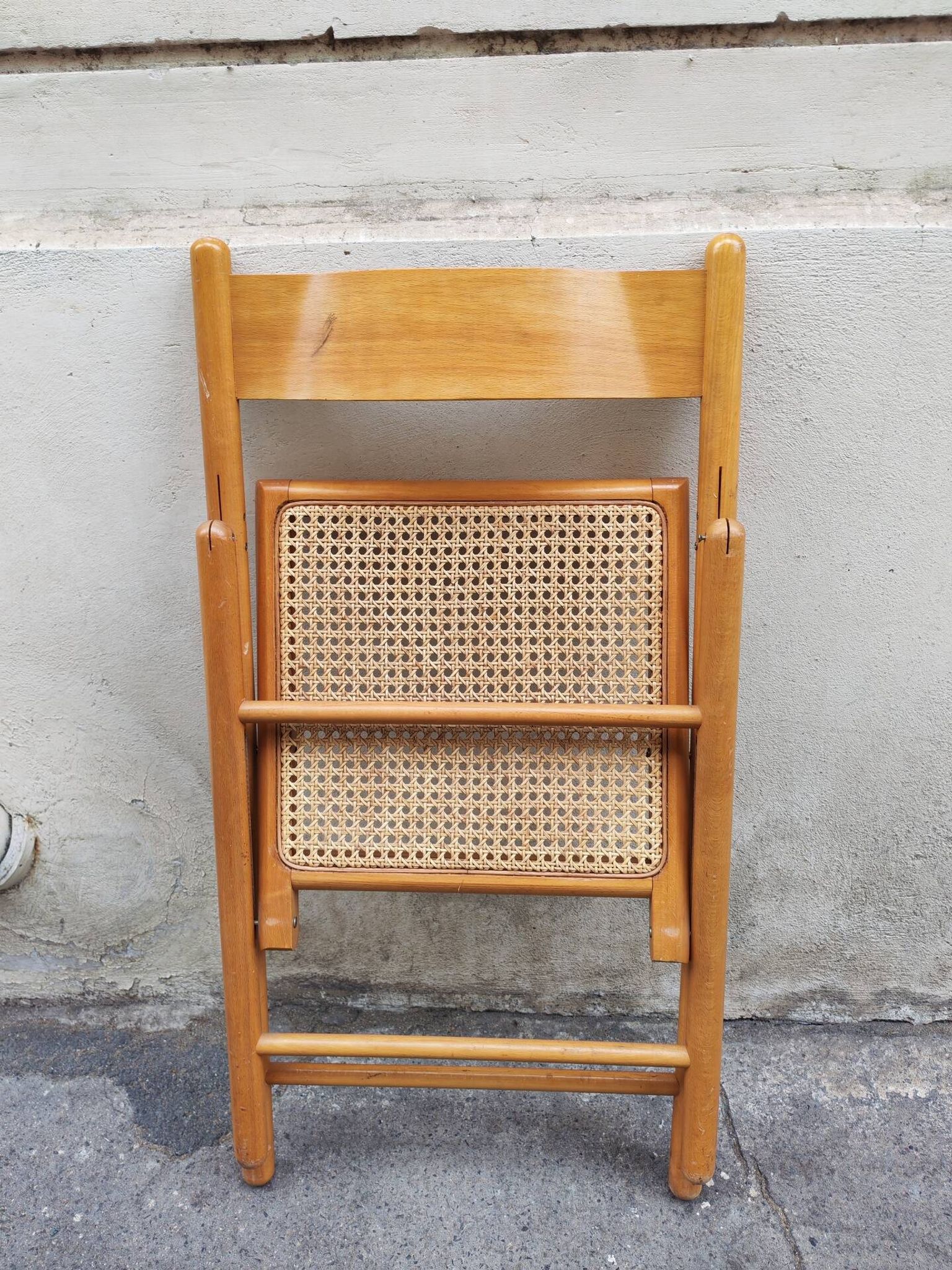 Wooden folding chair with cane from the 1980s.