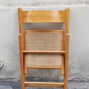Wooden folding chair with cane from the 1980s.