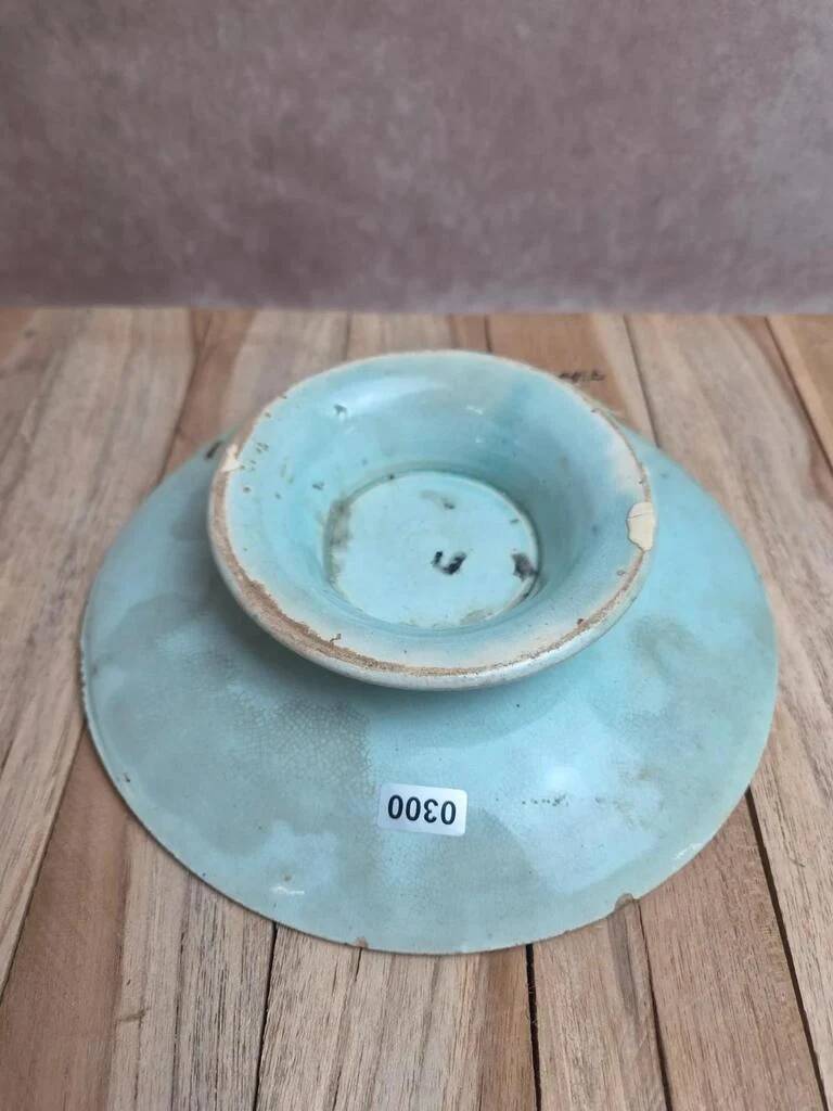 Old small compote dish in turquoise majolica with raised floral decoration.