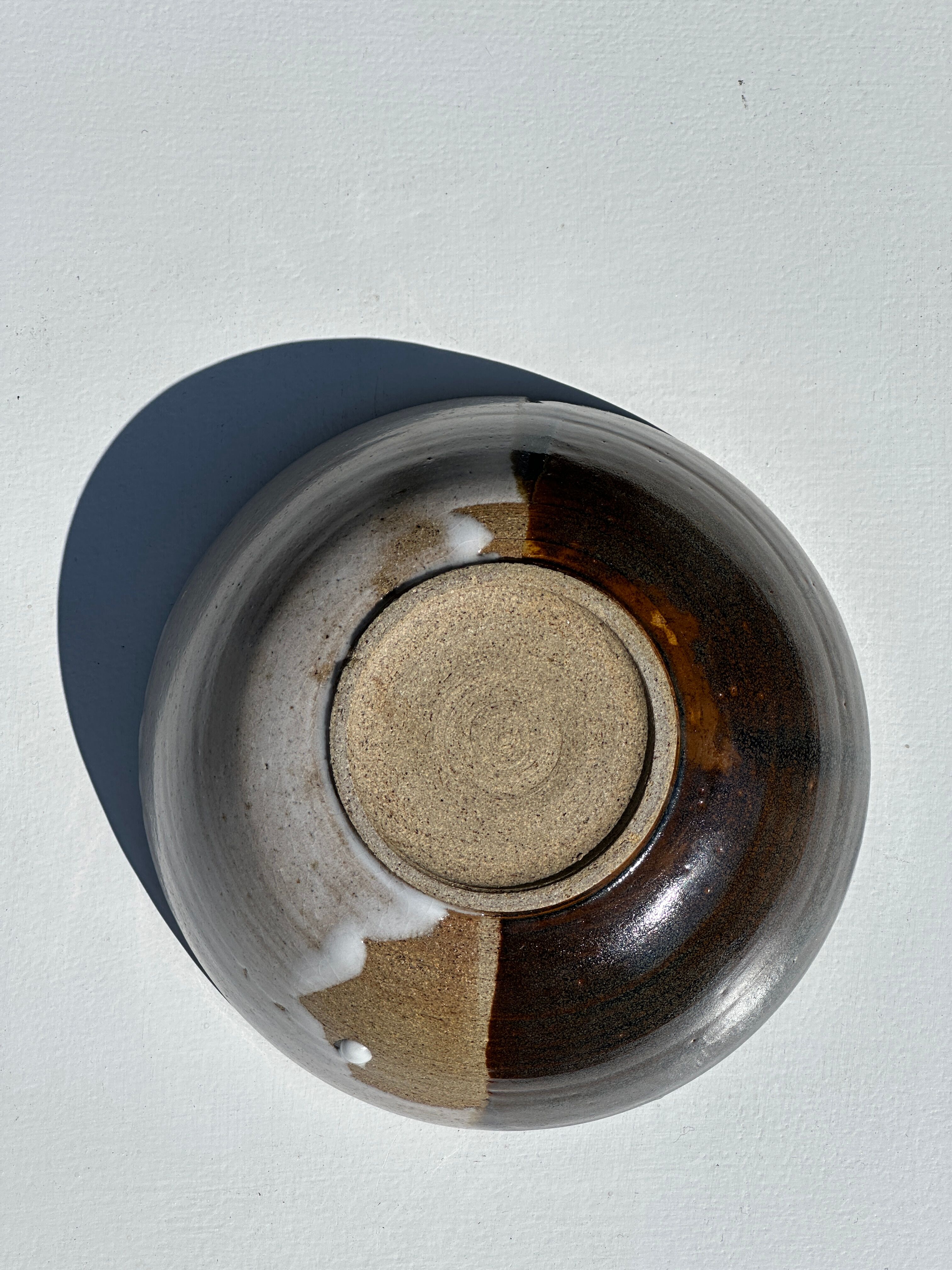 White and glossy brown two-tone ceramic bowl, matt earth