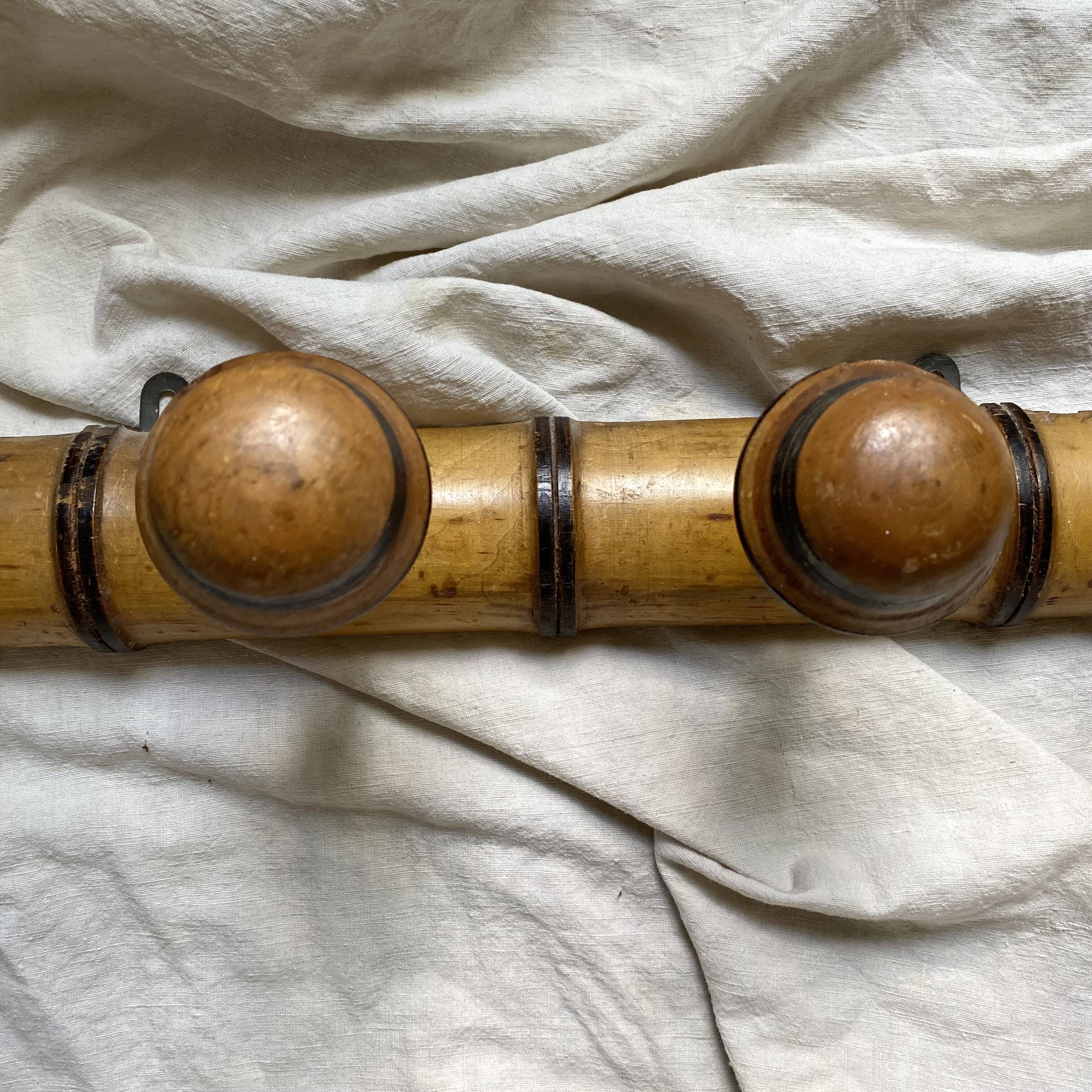 Antique wall-mounted coat rack in turned bamboo-style wood