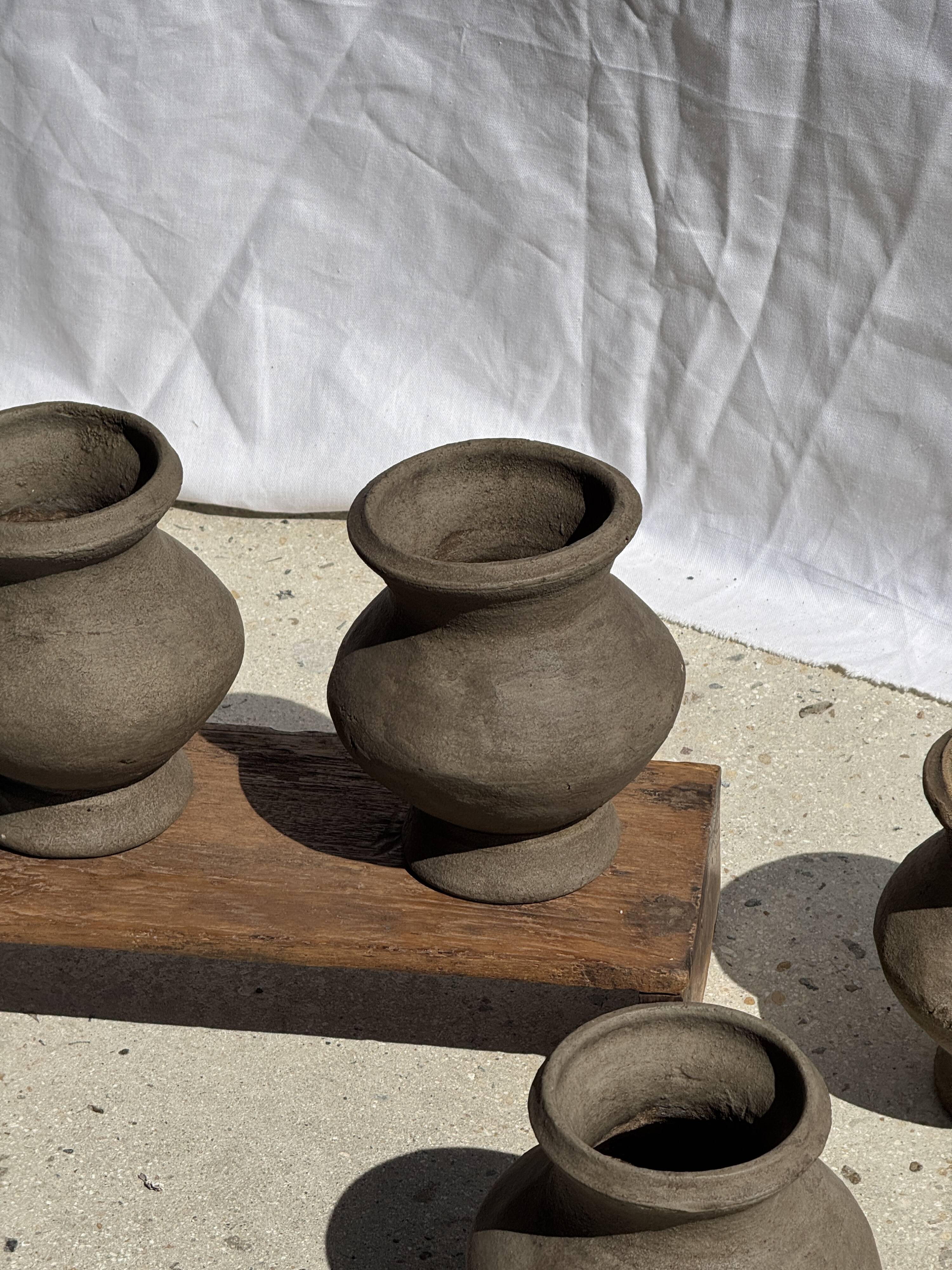 Small brutalist handcrafted terracotta vase with a pedestal, Indonesian, H19 D17.
