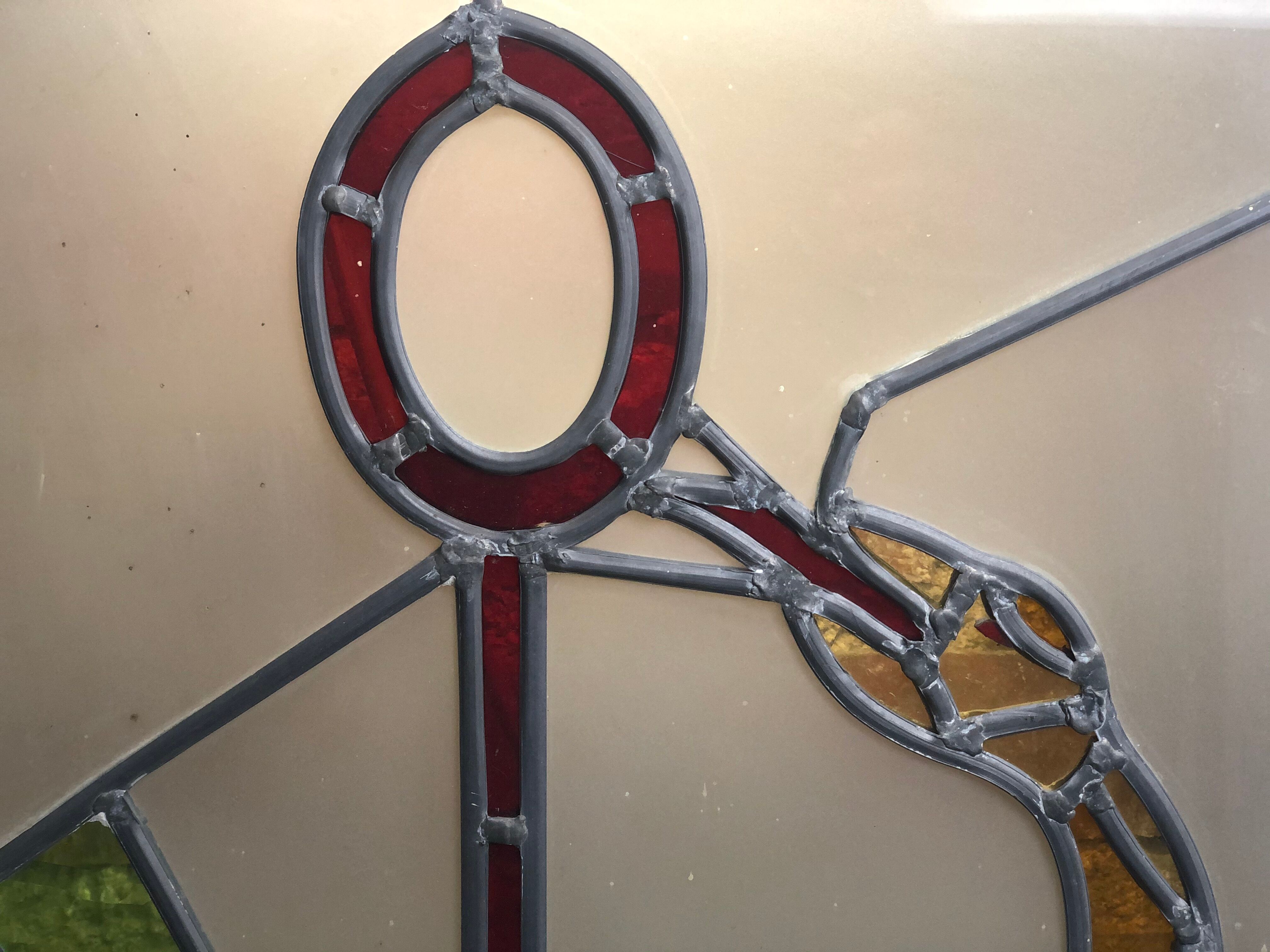 Old stained glass sign with deciduous decoration and microscope