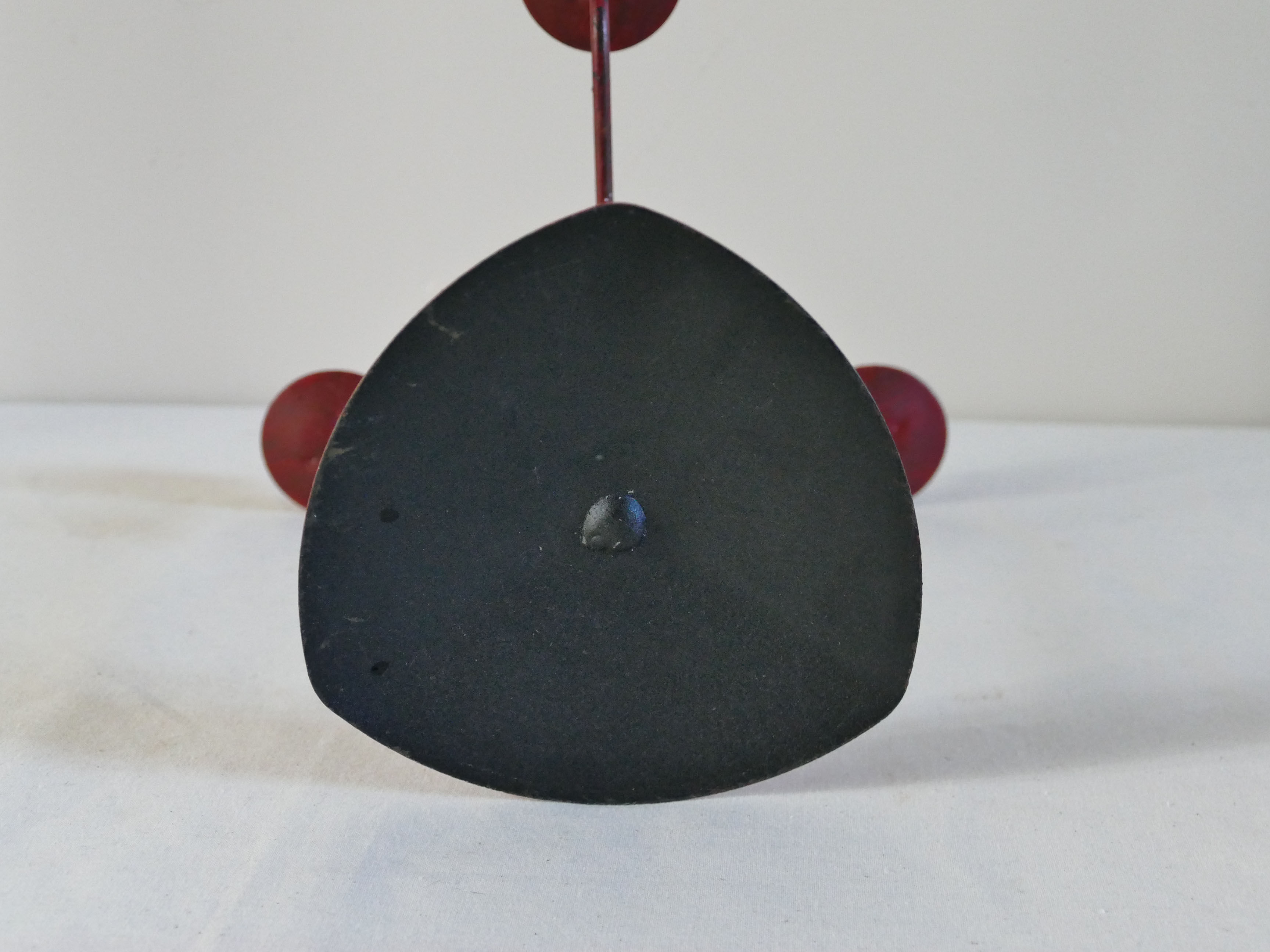 Red metal chandelier for three candles