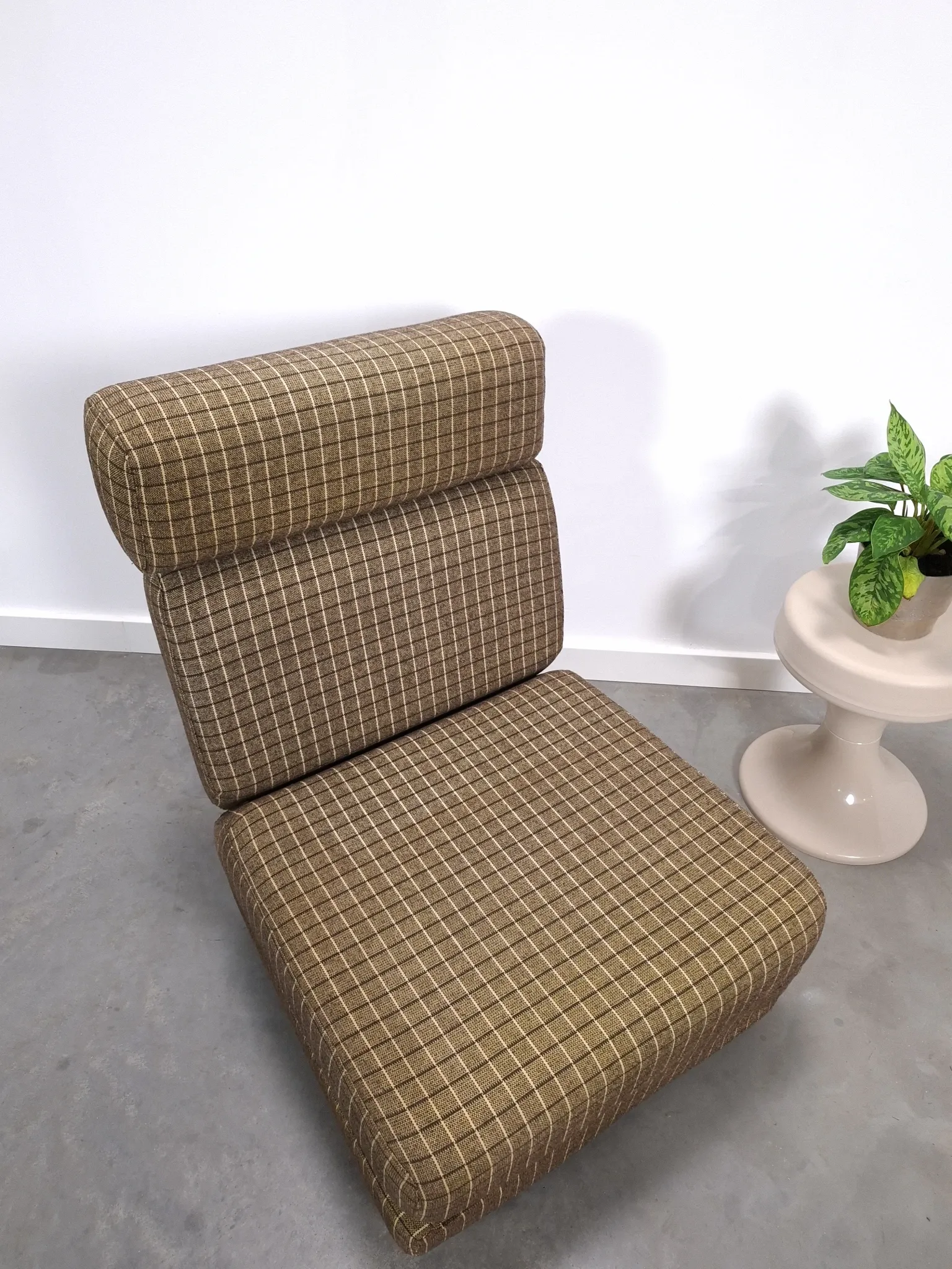 Vintage pull-out sofa bed, brown checked lounge chair with chrome.