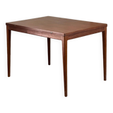 Extendable teak and teak veneer dining table