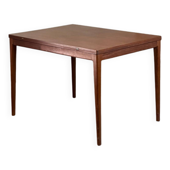 Extendable teak and teak veneer dining table