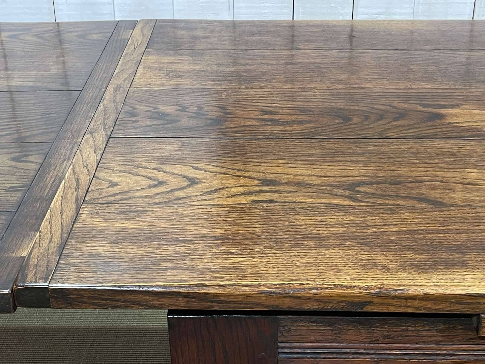 English monastery table with extensions from the late 19th century in elm and oak.