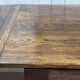 English monastery table with extensions from the late 19th century in elm and oak.