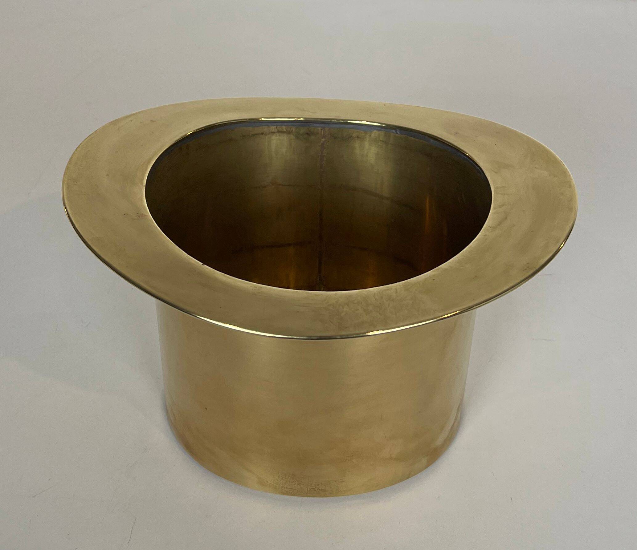 Champagne cooler shaped like a brass top hat.