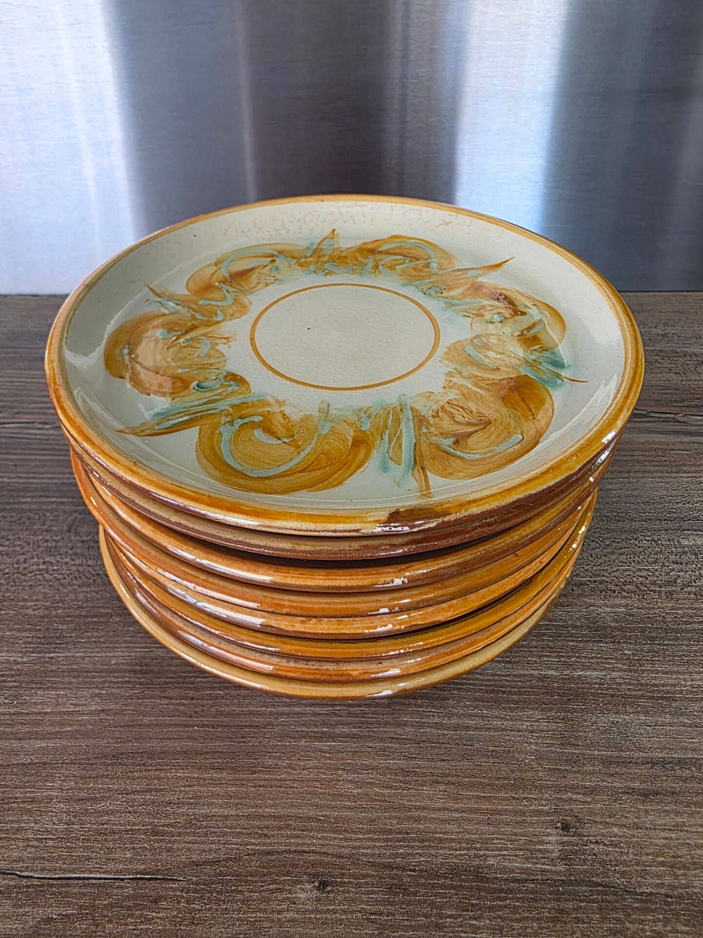 8 vintage dessert plates with a signed decoration.