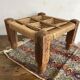 Low stool with carved wood and braided cord.
