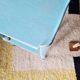 Small vintage bedside table in azure blue patina.