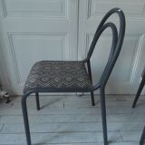 Industrial chair with a tubular metal frame in slate grey.