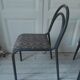 Industrial chair with a tubular metal frame in slate grey.