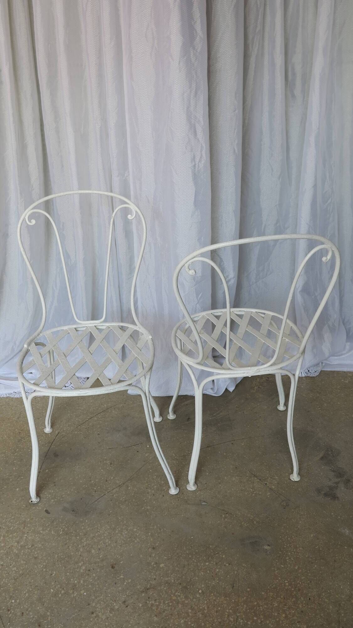 Pair of antique garden chairs, wrought iron, white paint.