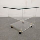 End of sofa with glass and plexiglass wheels from the 70s