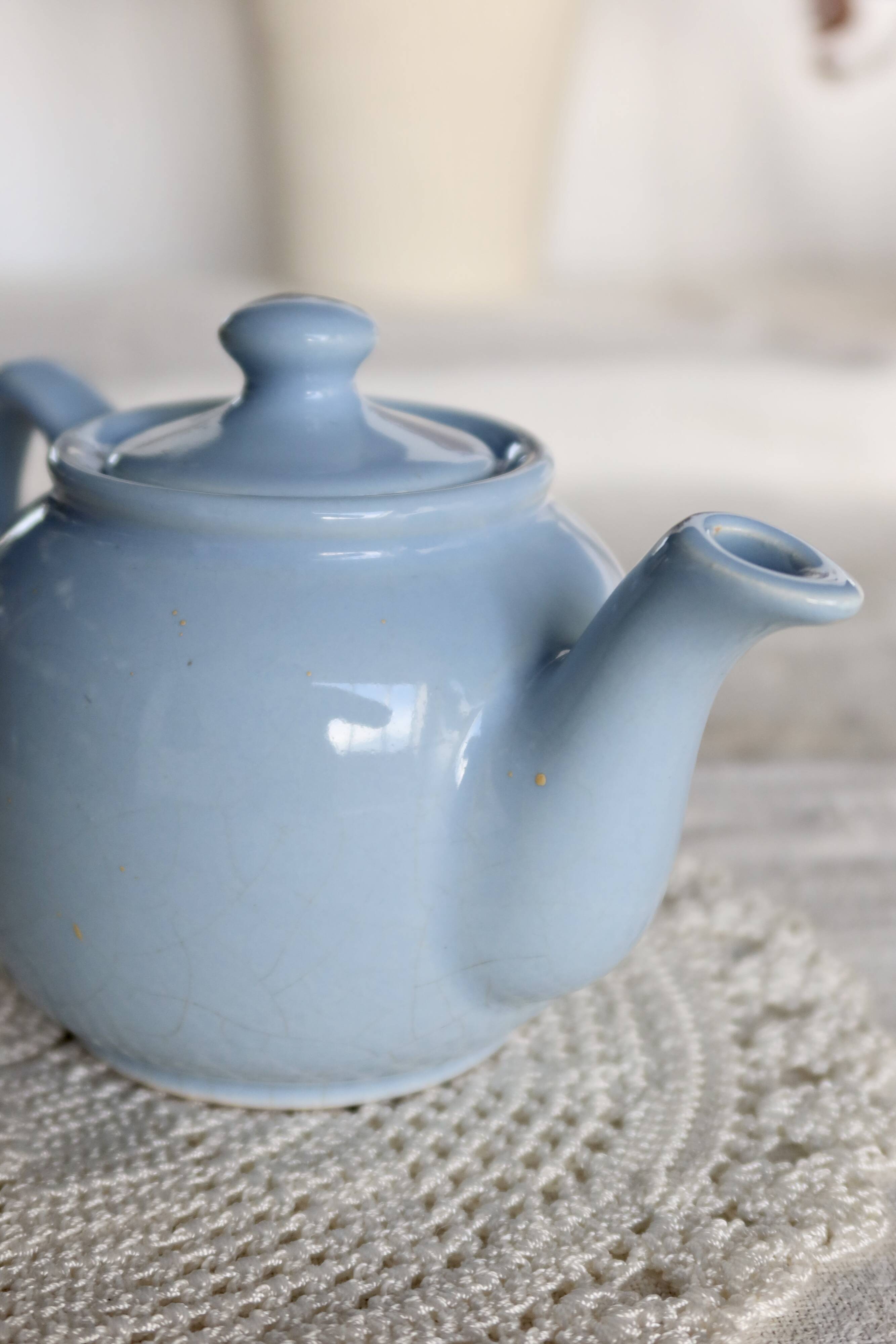Small vintage sky-blue earthenware teapot